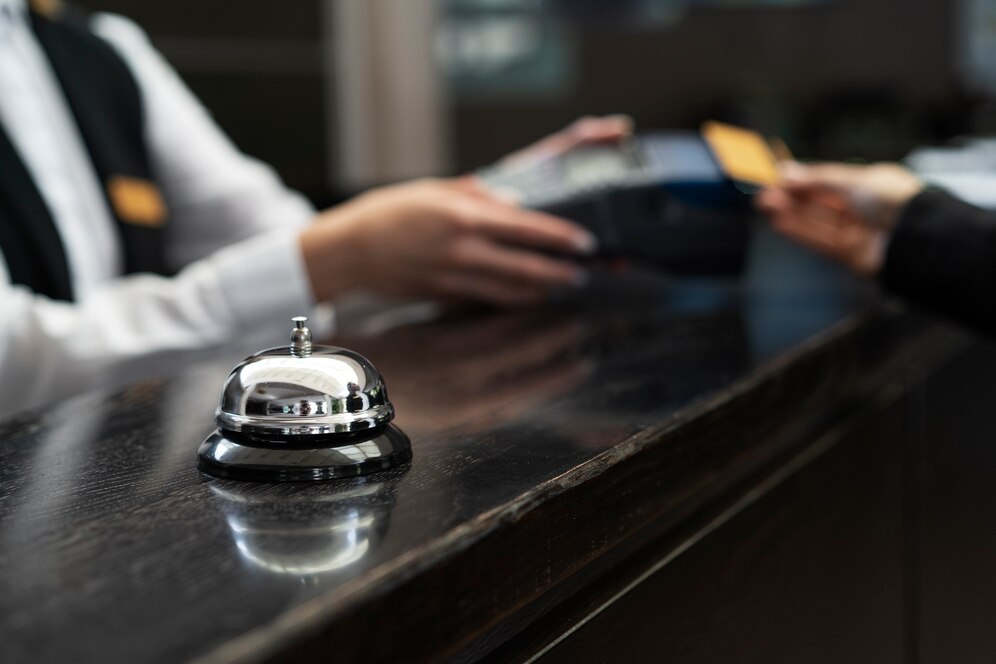 Concierge desk with a service bell and a payment transaction in progress