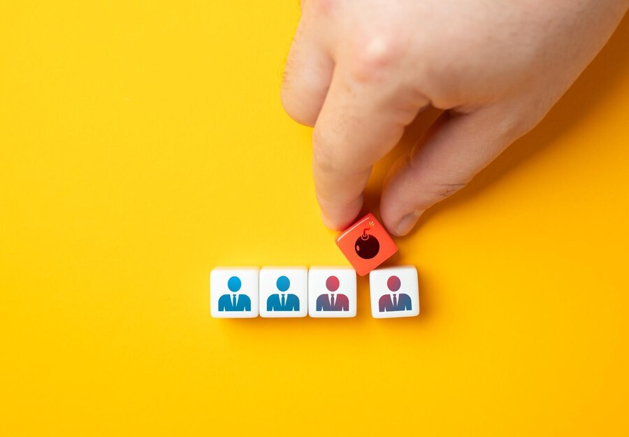 Hand selecting a game piece representing a person