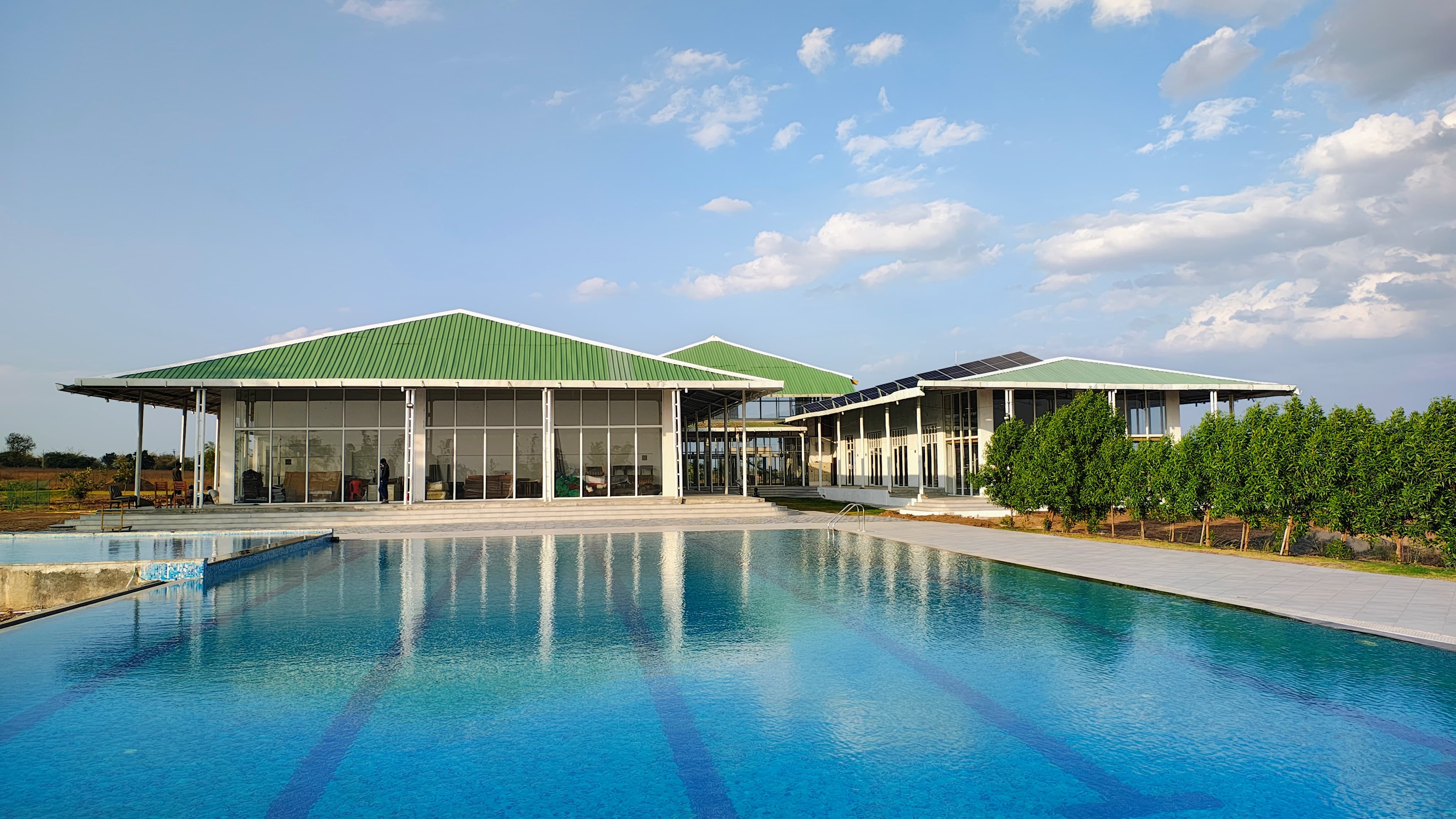 View of the clubhouse and swimming pool at Ambanagri Sports City.